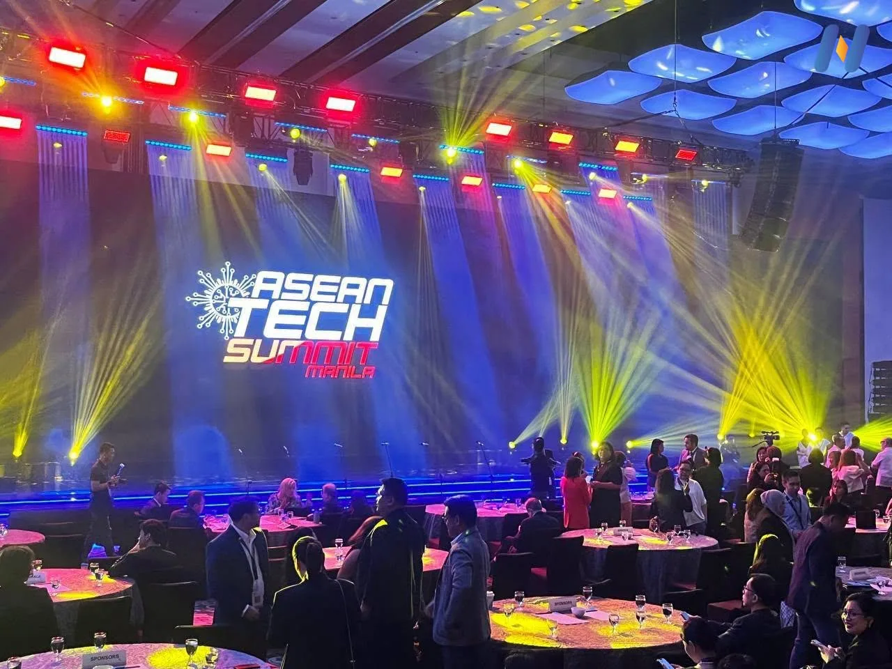 Novaluxia's photograph of the ASEAN TECH SUMMIT PHILIPPINES main stage at the ASEAN FinTech Summit Manila 2026, letters lit in blue above a full hall
