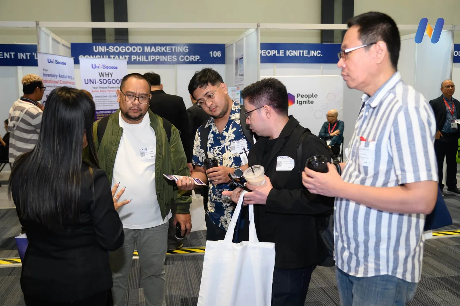 Visitors and exhibitors in the aisle between the stands on the expo floor