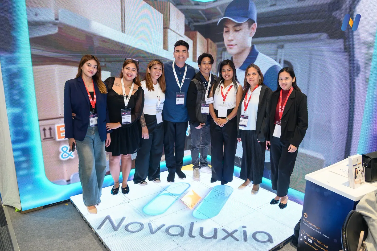 Novaluxia PH delegates photographed together in front of a branded backdrop at one of the platform's Philippine events