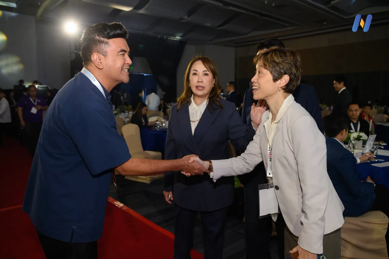 Novaluxia staff photographed shaking hands with guests at an event banquet