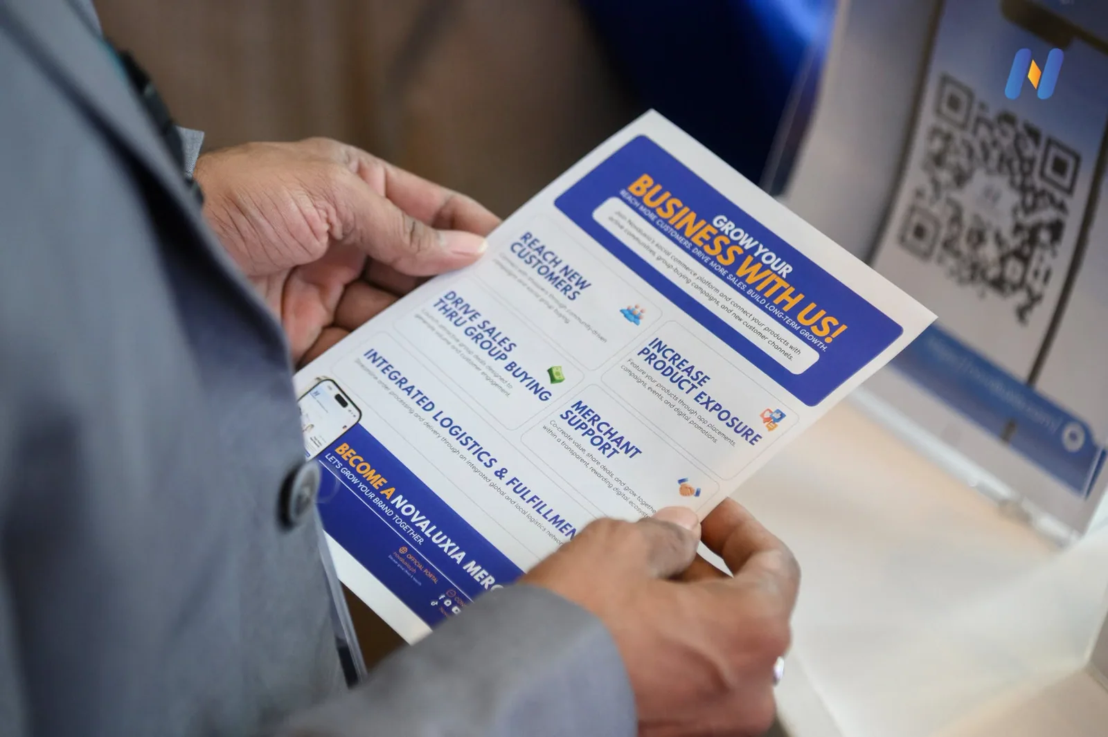 Novaluxia merchant recruitment flyer on the table at the retail expo booth