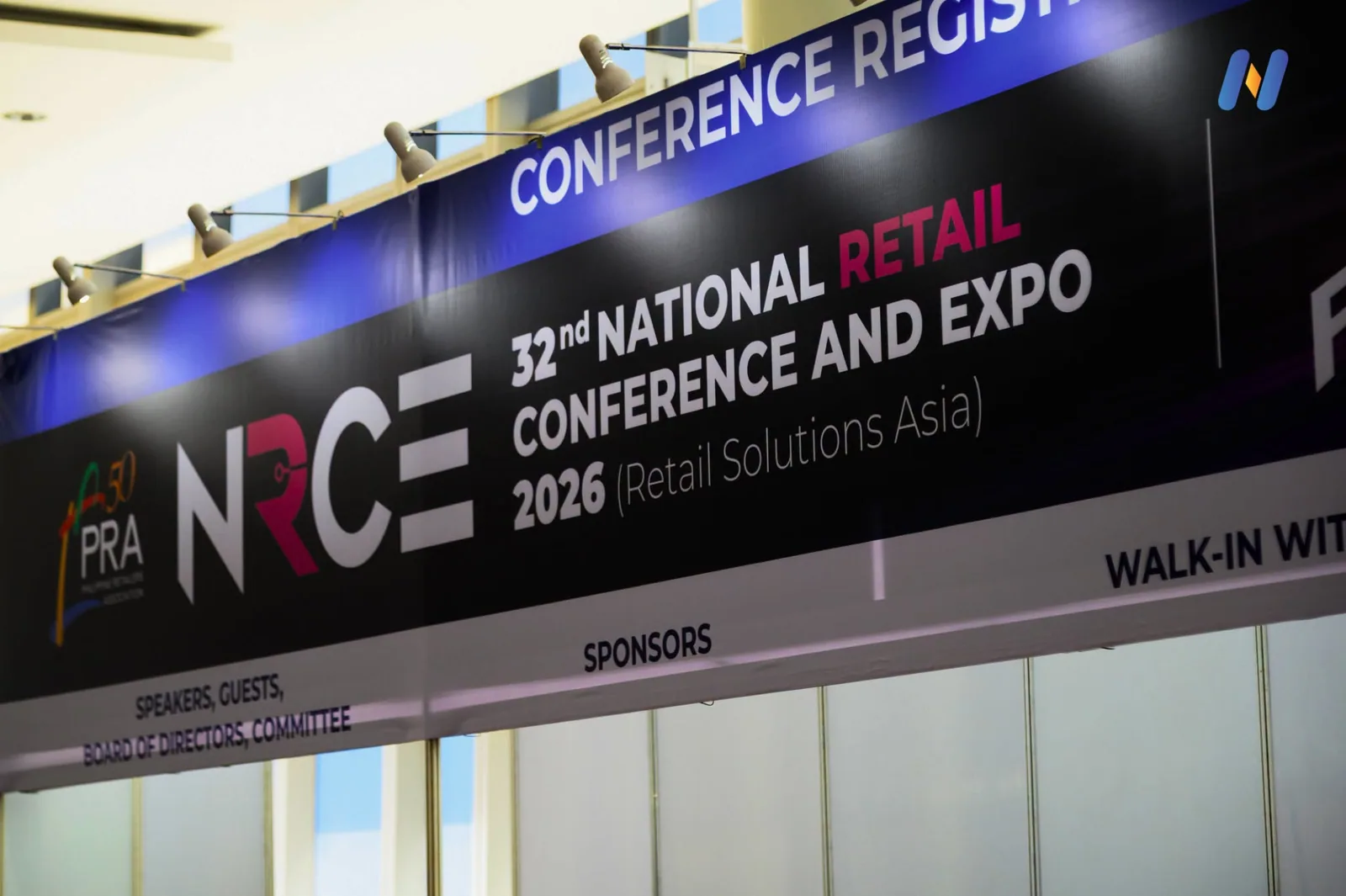 Novaluxia PH at the 32nd National Retail Conference and Expo 2026, the event signage naming Retail Solutions Asia above the conference registration desk