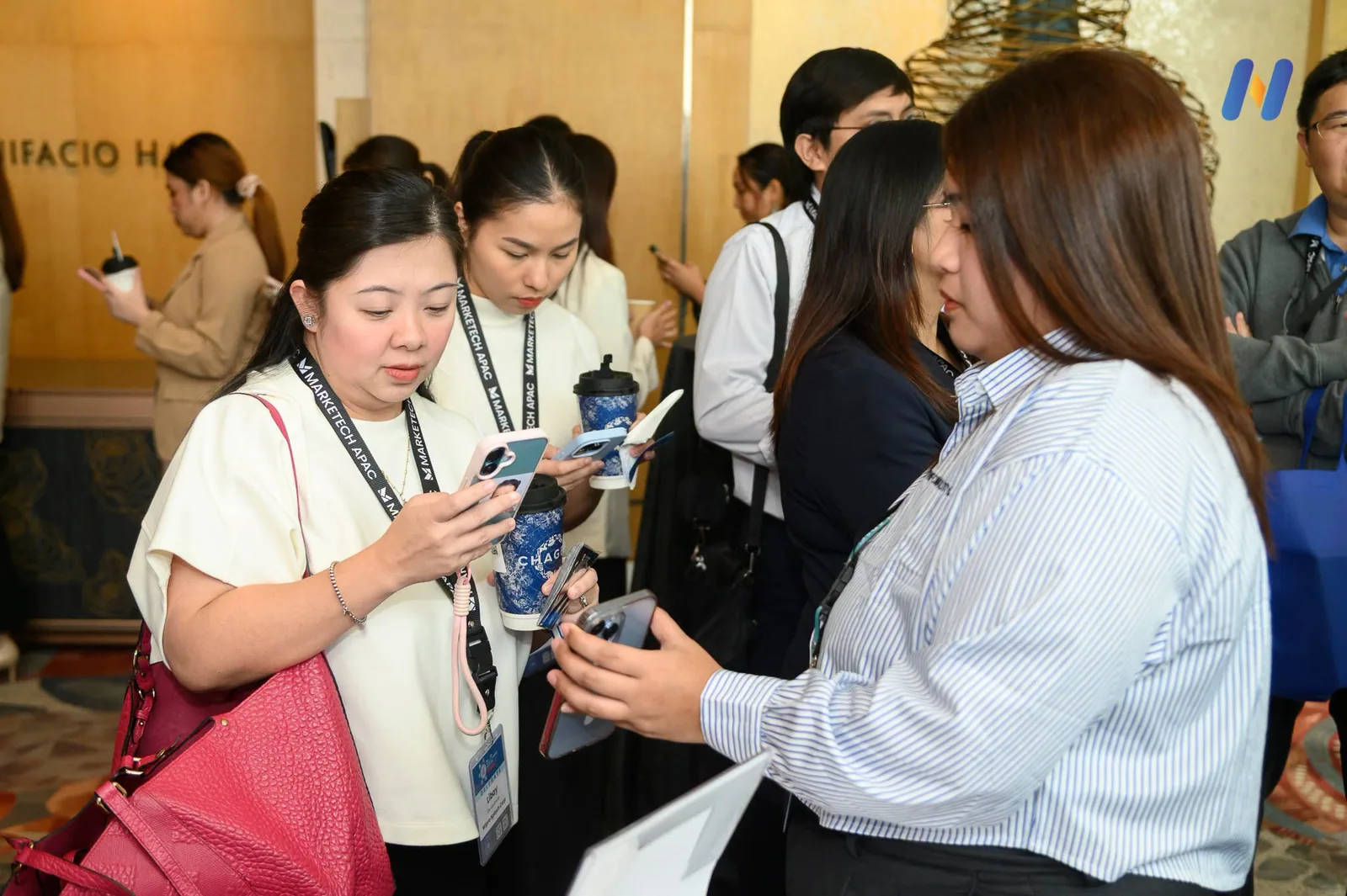 Visitors crowded at the Novaluxia booth counter with the app open on their phones